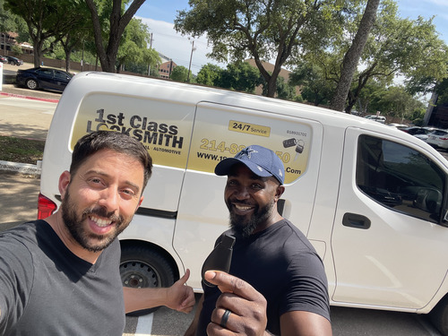 1st Class Locksmith Fort Worth technician smiling with a happy customer after a locksmith service, with a marked van in the background.